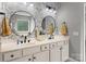 Double vanity bathroom featuring granite counters, round mirrors, and decorative wallpaper at 362 Windell Dr # 67, Fort Mill, SC 29708