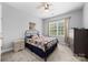 This cozy bedroom features carpet floors, a ceiling fan, and a large window for natural light at 362 Windell Dr # 67, Fort Mill, SC 29708