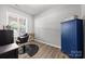 Bright bedroom with wood floors, window, salon chair, and blue storage cabinet at 362 Windell Dr # 67, Fort Mill, SC 29708