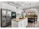 Open kitchen flows to the dining area, featuring stainless steel appliances and a granite island at 362 Windell Dr # 67, Fort Mill, SC 29708