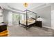 The main bedroom boasts a four-poster bed, tray ceiling, and lots of natural light at 362 Windell Dr # 67, Fort Mill, SC 29708