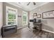 Cozy office with wood floors, natural light, dual monitor desk setup, and a view of the outdoors at 362 Windell Dr # 67, Fort Mill, SC 29708