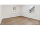 Bright bedroom featuring hardwood floors, two windows, and white trim at 3726 The Plaza None, Charlotte, NC 28205