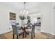 Open dining area with a round table, designer lighting, and seamless access to the living room at 3726 The Plaza None, Charlotte, NC 28205