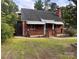 Quaint brick home with awnings over the porches, a chimney, and a grassy front yard at 3726 The Plaza None, Charlotte, NC 28205
