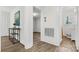 Hallway featuring hardwood floors and an archway to a sunny room with a view at 3726 The Plaza None, Charlotte, NC 28205