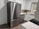 Modern kitchen with stainless steel appliances, white cabinetry, and solid surface countertops at 3726 The Plaza None, Charlotte, NC 28205