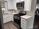 Updated kitchen featuring a stainless steel oven, ample cabinetry, and solid surface countertops at 3726 The Plaza None, Charlotte, NC 28205