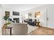 Airy living room featuring sleek furniture, a decorative fireplace, and natural light at 3726 The Plaza None, Charlotte, NC 28205