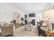 Bright living room with fireplace, large windows, plush carpet, and stylish furniture at 3726 The Plaza None, Charlotte, NC 28205
