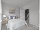Cozy bedroom with carpet, neutral tones, and a glimpse of the staircase through an open door at 3737 S Tryon St, Charlotte, NC 28217