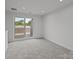 Light filled bedroom with sliding door access to the balcony at 3737 S Tryon St, Charlotte, NC 28217