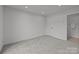Spacious bedroom with plush carpeting and a view of the attached bathroom at 3737 S Tryon St, Charlotte, NC 28217