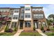 Beautiful townhome showcasing a brick facade with stylish accents and a well-manicured front lawn at 3737 S Tryon St, Charlotte, NC 28217