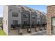 The rear of a modern townhouse featuring a private balcony and garage at 3737 S Tryon St, Charlotte, NC 28217