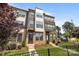 A charming townhouse with a landscaped yard and a black metal fence in front at 3737 S Tryon St, Charlotte, NC 28217