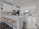 Modern kitchen features a center island, sleek white cabinets, and stainless steel appliances at 3737 S Tryon St, Charlotte, NC 28217