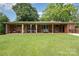 Backyard patio and covered porch area with string lights at 4044 Somerdale Ln, Charlotte, NC 28205
