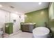 This bright bathroom features a soaking tub, glass shower, and double vanity at 4044 Somerdale Ln, Charlotte, NC 28205