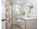 Updated bathroom with shower/tub, gray tile floor, and marble countertop vanity at 4044 Somerdale Ln, Charlotte, NC 28205