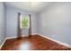 Bedroom with hardwood floors, painted walls and window allowing natural light at 4044 Somerdale Ln, Charlotte, NC 28205