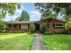 Charming brick home with a well-manicured lawn, walkway and professionally landscaped front yard at 4044 Somerdale Ln, Charlotte, NC 28205