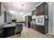 Functional kitchen with sleek black cabinets, stainless steel appliances and an eat-in breakfast bar at 4044 Somerdale Ln, Charlotte, NC 28205