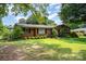 Expansive front lawn showcases a classic brick home with mature landscaping at 4044 Somerdale Ln, Charlotte, NC 28205