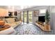 Relaxing living room with access to backyard, featuring a comfortable sofa and stylish rug at 4044 Somerdale Ln, Charlotte, NC 28205