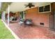 Covered outdoor patio area with brick flooring, ceiling fans, and ample seating at 4044 Somerdale Ln, Charlotte, NC 28205