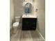 Modern half-bath with a stylish black vanity, gold accents, and sleek fixtures at 4435 Cornett Dr # 30, Iron Station, NC 28080