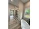 Beautiful bathroom featuring soaking tub and glass enclosed shower with luxurious black fixtures and hardware at 4435 Cornett Dr # 30, Iron Station, NC 28080