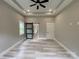 Large bedroom with ceiling fan, tray ceiling, recessed lights, and sliding barn door leading to ensuite bathroom at 4435 Cornett Dr # 30, Iron Station, NC 28080