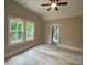 Light-filled bedroom with wood flooring, two windows, and a ceiling fan at 4435 Cornett Dr # 30, Iron Station, NC 28080