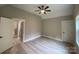 Spacious bedroom with two doorways, a ceiling fan, and wood flooring at 4435 Cornett Dr # 30, Iron Station, NC 28080