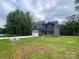 Charming two-story home featuring a blue and gray exterior, a spacious driveway, and a well-manicured lawn at 4435 Cornett Dr # 30, Iron Station, NC 28080