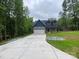 Charming two-story home featuring a blue and gray exterior, a spacious driveway, and a well-manicured lawn at 4435 Cornett Dr # 30, Iron Station, NC 28080