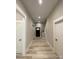 Bright hallway with hardwood floors, white trim, and doors with black hardware at 4435 Cornett Dr # 30, Iron Station, NC 28080