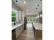 Bright modern kitchen with white cabinets, stainless appliances, quartz countertops, and large island with pendant lights at 4435 Cornett Dr # 30, Iron Station, NC 28080