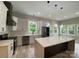 Modern kitchen featuring white cabinets, stainless steel appliances, quartz countertops, and island with pendant lights at 4435 Cornett Dr # 30, Iron Station, NC 28080