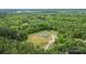 Breathtaking aerial view of a cozy home surrounded by dense green trees, offering privacy and tranquility at 4518 Logging Rd, Lancaster, SC 29720