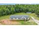 Charming home with neat landscaping, set against a backdrop of lush greenery and a storage shed at 4518 Logging Rd, Lancaster, SC 29720