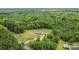 Breathtaking aerial view of a cozy home surrounded by dense green trees, offering privacy and tranquility at 4518 Logging Rd, Lancaster, SC 29720