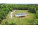 Aerial view of a well-maintained home with a deck and yard, complemented by vibrant greenery all around at 4518 Logging Rd, Lancaster, SC 29720