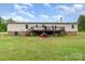 Backyard of the home featuring a deck, shed, and wooded space at 4518 Logging Rd, Lancaster, SC 29720
