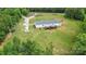 Aerial view of a well-maintained home with a deck and yard, complemented by vibrant greenery all around at 4518 Logging Rd, Lancaster, SC 29720