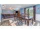 Elegant dining area with a wooden table, view into living room, and bright natural light from window at 4518 Logging Rd, Lancaster, SC 29720