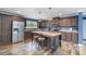 Open kitchen featuring stainless steel appliances, a center island with seating, and wood cabinets at 4518 Logging Rd, Lancaster, SC 29720