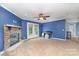 Cozy living room featuring a stone fireplace, ceiling fan, and access to the backyard at 4518 Logging Rd, Lancaster, SC 29720