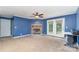 Bright living room featuring a stone fireplace, ceiling fan, and neutral carpet at 4518 Logging Rd, Lancaster, SC 29720